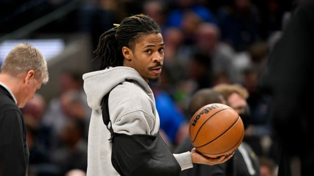 Memphis Grizzlies guard Ja Morant wears an arm sling on the bench.